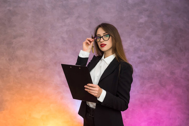 Beautiful business lady pointing with pen on clipboard proposing sign a contract - Foto, Bild