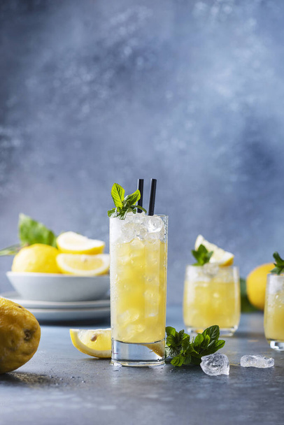 Fresh summer cocktail with lemons, mint and ice, selective focus image - Fotó, kép