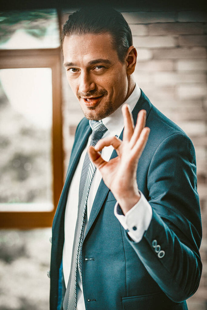 Smiling Professional businessman Showing Ok Sign - Foto, Imagen