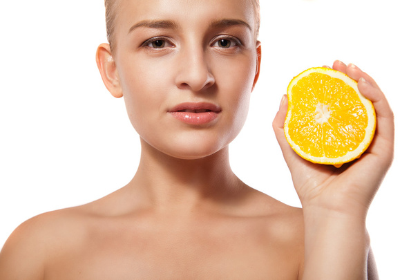 Young beautiful woman with orange over white - Zdjęcie, obraz