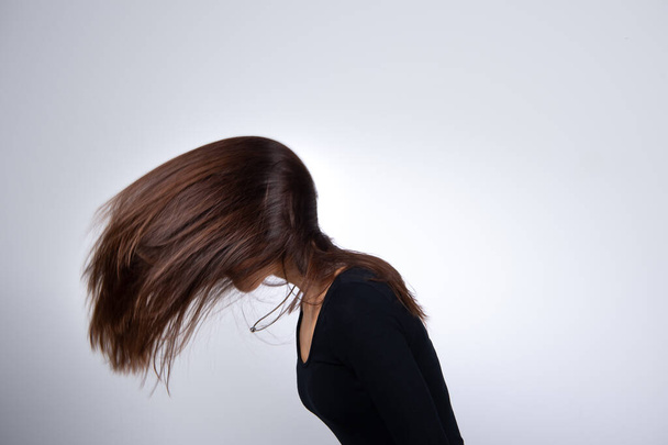 Girl shaking her long straight brown hair - Photo, image