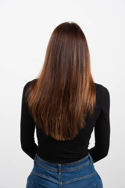 head of girl seen from the back showing fantastic long and straight hair very well-groomed - Foto, Imagen