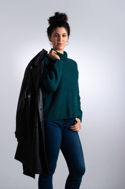 Portrait of girl with elegant clothing, dark leather jacket on dark green wool sweater - Photo, image