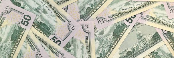 Many US fifty dollar bills on flat background surface close up. Flat lay top view. Abstract success or business concept - 写真・画像
