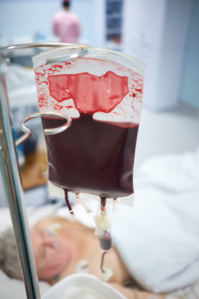 Closeup view of blood transfusion in intensive care unit. - Photo, Image