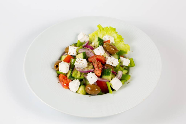 A salad with feta cheese olives and fresh vegetables - Foto, immagini