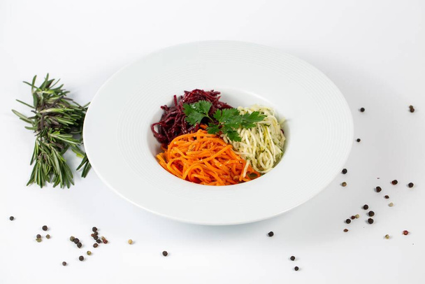 A closeup shot of pesto pasta with fresh beetle and carrot beautifully served - Fotó, kép