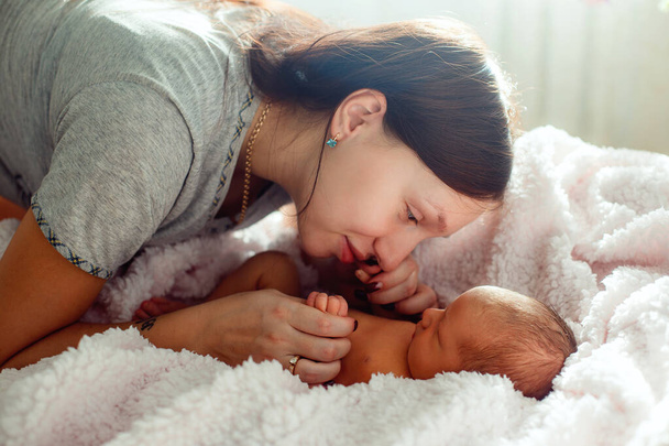 Mom and newborn baby on white background - Фото, изображение