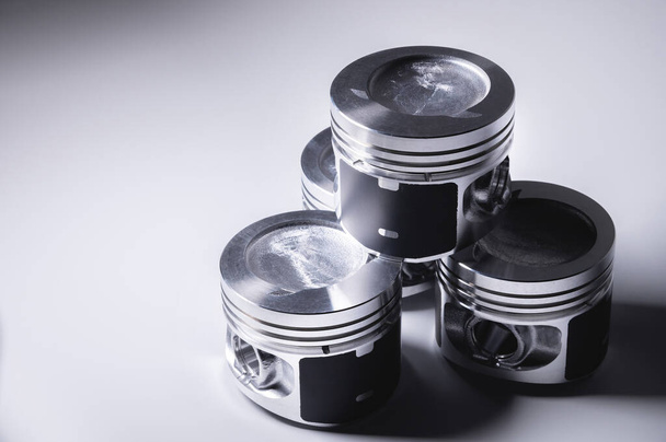 New parts for the internal combustion engine. Pistons on a gray gradient background - Fotó, kép
