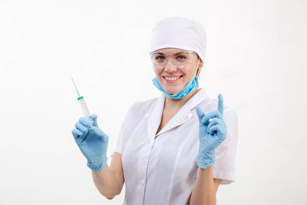 Doctor in a white coat holding a syringe - Photo, Image