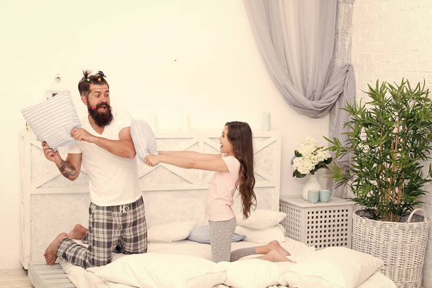 Time flies when you are having fun. Happy family have fun together. Little child and bearded man fight for fun. Pillow fight. Play games. Fun and entertainment. Family life - Fotoğraf, Görsel