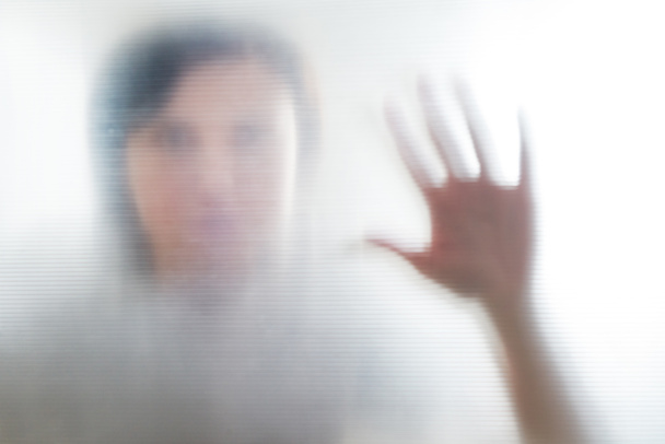 Diffused silhouette of female hands, view with shadow through plastic - Foto, Imagen