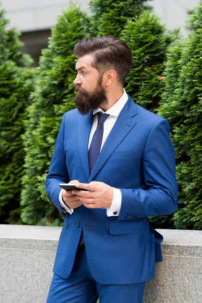 Check out updates. Text messaging by mobile phone. Mobile marketing. SMS messaging business. Bearded man texting sms. Businessman send sms using smartphone. Sms message. Short message service - 写真・画像