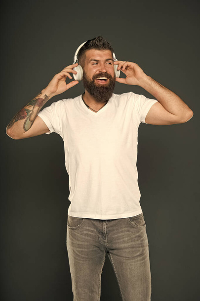Dont stop music. Bearded man listen to music grey background. Hipster wear headphones playing music. Music is fun. Fun and entertainment - Photo, Image
