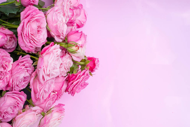Bushy pink roses on a delicate pink background. Concept of love, wedding. Copy space. - Fotó, kép
