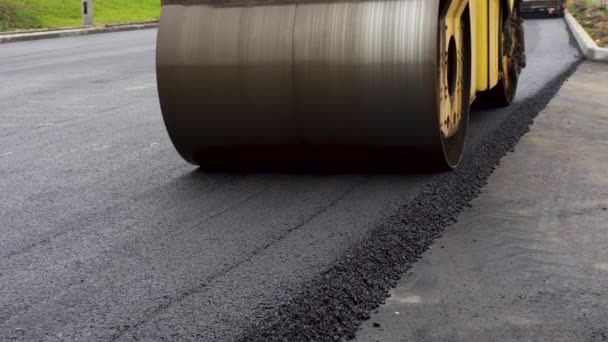 A large yellow steamroller flatten hot asphalt. Builds a new road - Footage, Video