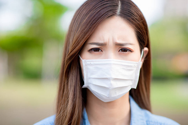 Asian woman look you unhappily with surgical mask face protection - Photo, Image