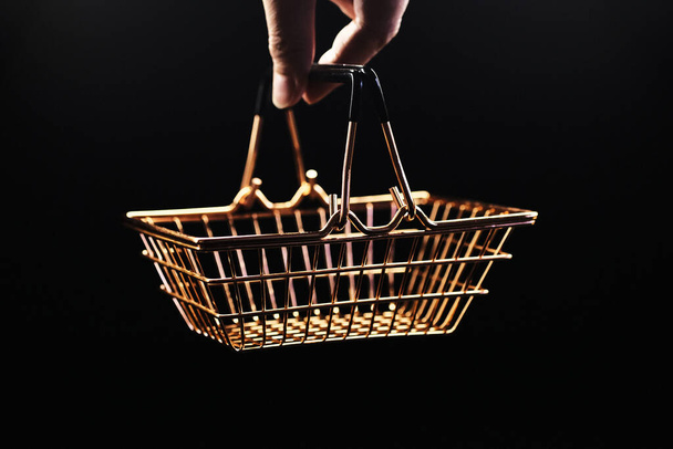 empty golden metal mini basket for a store in a hand - Φωτογραφία, εικόνα