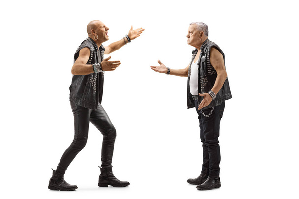 Full length profile shot of two angry punk men having an argument isolated on white background - Photo, image