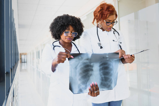 african doctors looking at patient's x-ray at hospital - 写真・画像