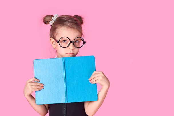 Portrait of her she nice foxy lovely attractive cheerful positive school girl holding in hands hiding behind opened book exam preparation isolated over pink background - Foto, Bild