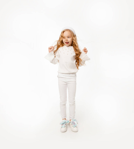 A girl with long hair, dressed in white clothes, bounces up - Photo, Image