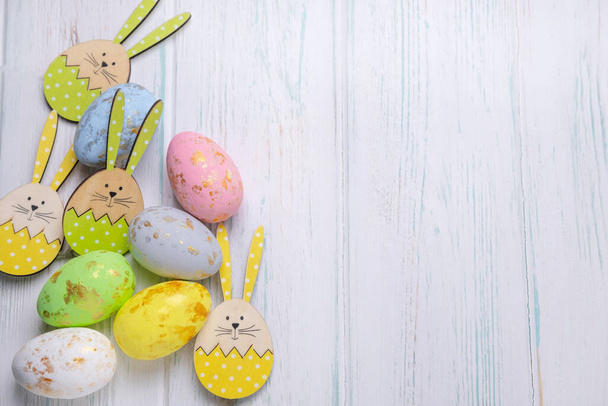 Frame for text with easter eggs on a light wooden background. Easter background with place for text. - Foto, afbeelding