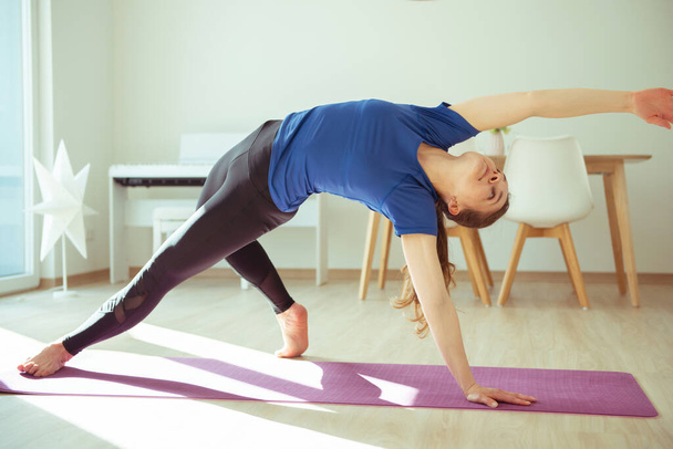Yoga workout at home due to coronavirus quarantine - Fotoğraf, Görsel