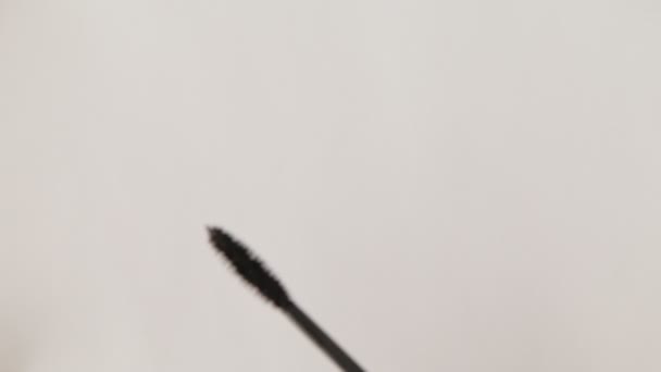 Mascara-Pinsel auf Weiß. Applikatorpinsel mit schwarzer Mascara-Nahaufnahme, isoliert auf weißem Hintergrund - Filmmaterial, Video