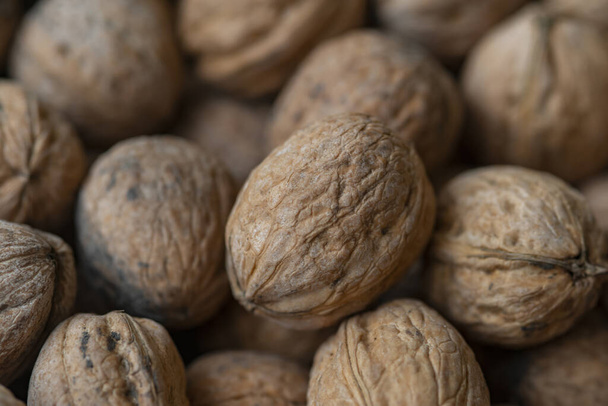 Lot of  walnuts in the pile.Background of fresh walnuts. - Foto, Imagen
