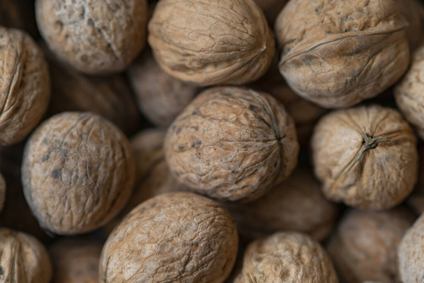 Lot of  walnuts in the pile.Background of fresh walnuts. - Foto, Imagem