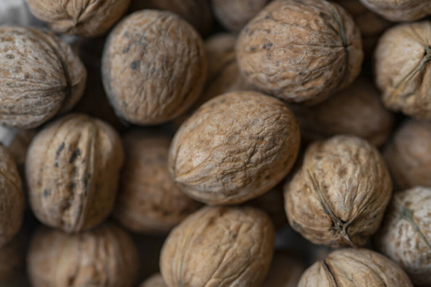 Lot of  walnuts in the pile.Background of fresh walnuts. - Foto, Imagem