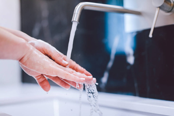 Washing hands with foam soap. Hygiene and healthcare, preventing coronavirus. - Фото, зображення