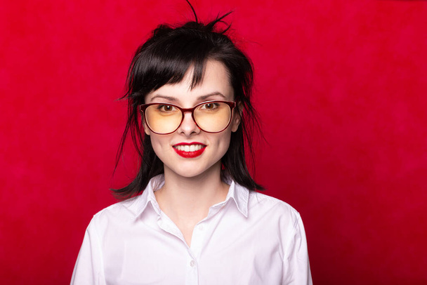 female manager with red lips, red background - Фото, изображение