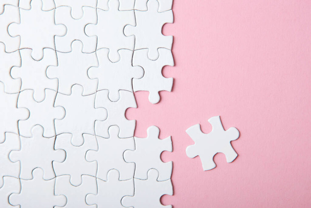 White puzzle on a colored background top view. - Photo, Image