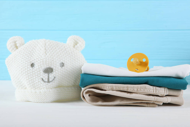 a stack of baby clothes on a light background. - Photo, Image