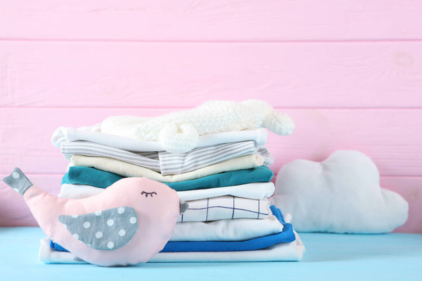 a stack of baby clothes on a light background. - Photo, Image