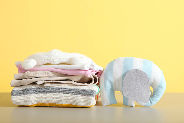 a stack of baby clothes on a light background. - Φωτογραφία, εικόνα