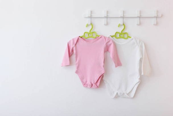 Baby clothes on a hanger. Place for text, minimalism. - Photo, Image