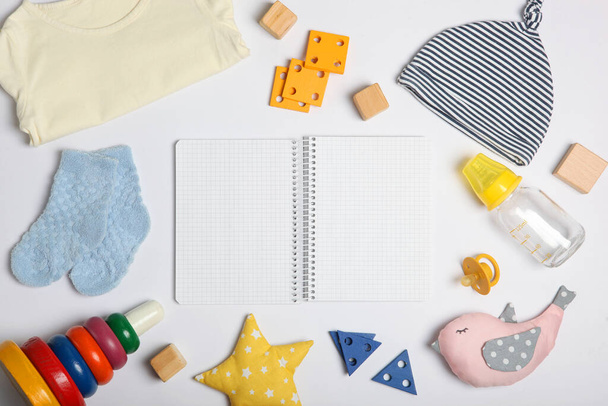 Bebek geçmişi. Renkli arka plan görünümlü bir çocuk için giysi, defter ve aksesuarlar. Çocuk için gerekli şeylerin bir listesini yap, hastanedeki şeylerin bir listesini. Metin ve minimalizm için bir yer - Fotoğraf, Görsel