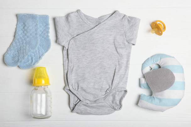 Baby background. Clothing and accessories for a baby on a colored background top view. A place to insert text, minimalism. - Fotoğraf, Görsel