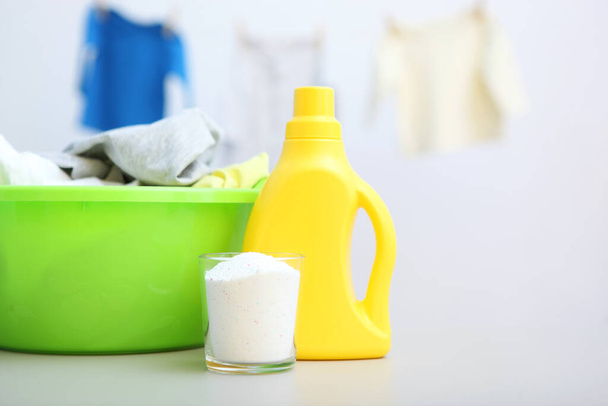 Baby clothes and detergents on the table. Baby clothes care concept. - Photo, Image