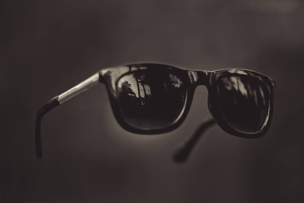Black sunglasses for protection from the sun in zero gravity - Foto, Imagem