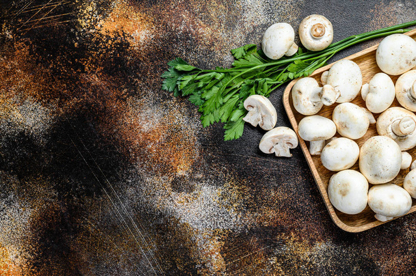 mushroom champignon in a bamboo bowl. Dark background. Top view. Space for text. - Photo, Image