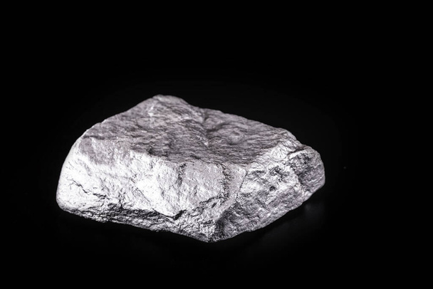 small titanium stone, metal used in light alloys. Macro photography of rough ore. - Photo, Image