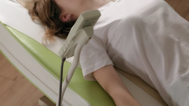 A woman lies on a massage electronic bed. - Footage, Video