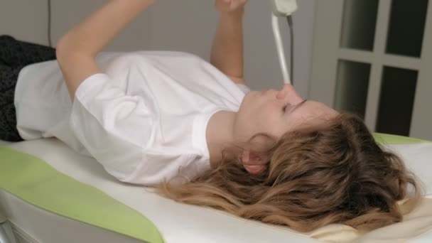 Een vrouw ligt op een massage elektronisch bed. - Video