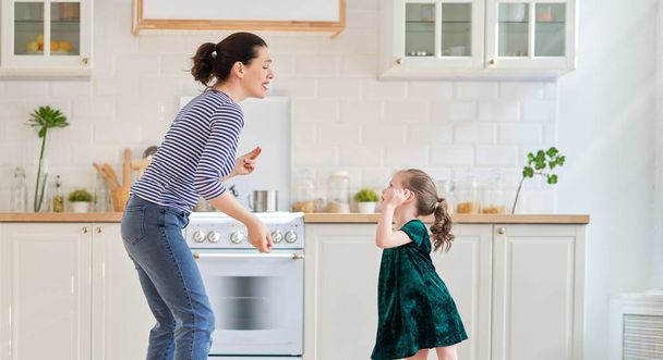  Happy mother's day! Child daughter and mom cooking and having fun in the kitchen at home. Family holiday and togetherness. - Φωτογραφία, εικόνα