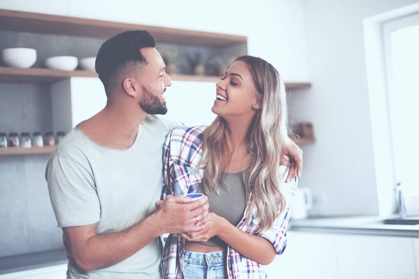 happy young couple in kitchen in good morning time - Foto, imagen