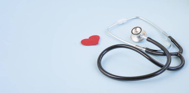 Stethoscope and red heart on a blue background. Greeting background. National doctor's day. Happy nurse 's day. Health day. Top view, a copy of the space. - Photo, Image